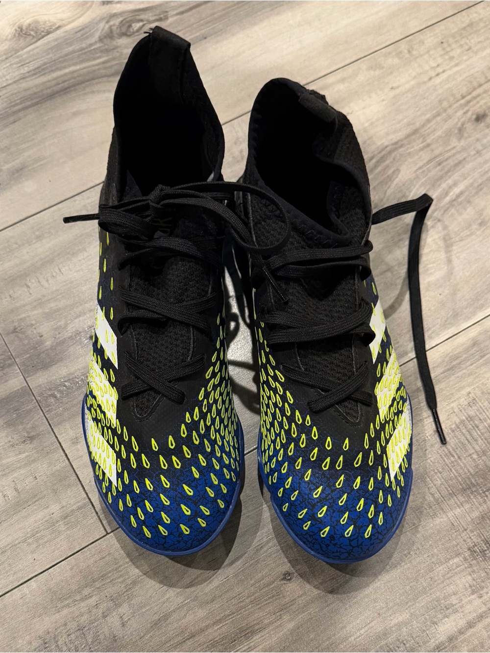 Kids Black Athletic Soccer Cleats with Yellow and Blue Accents